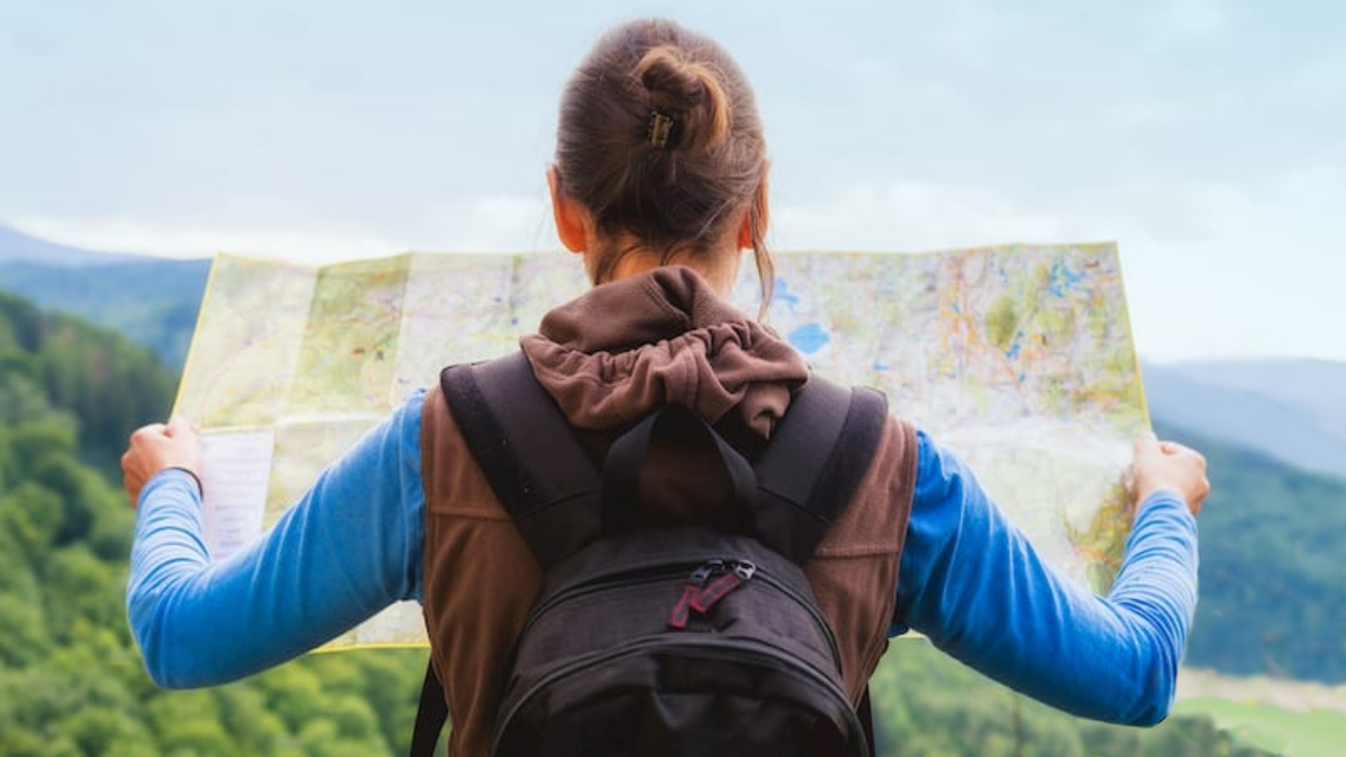 female hiker with map